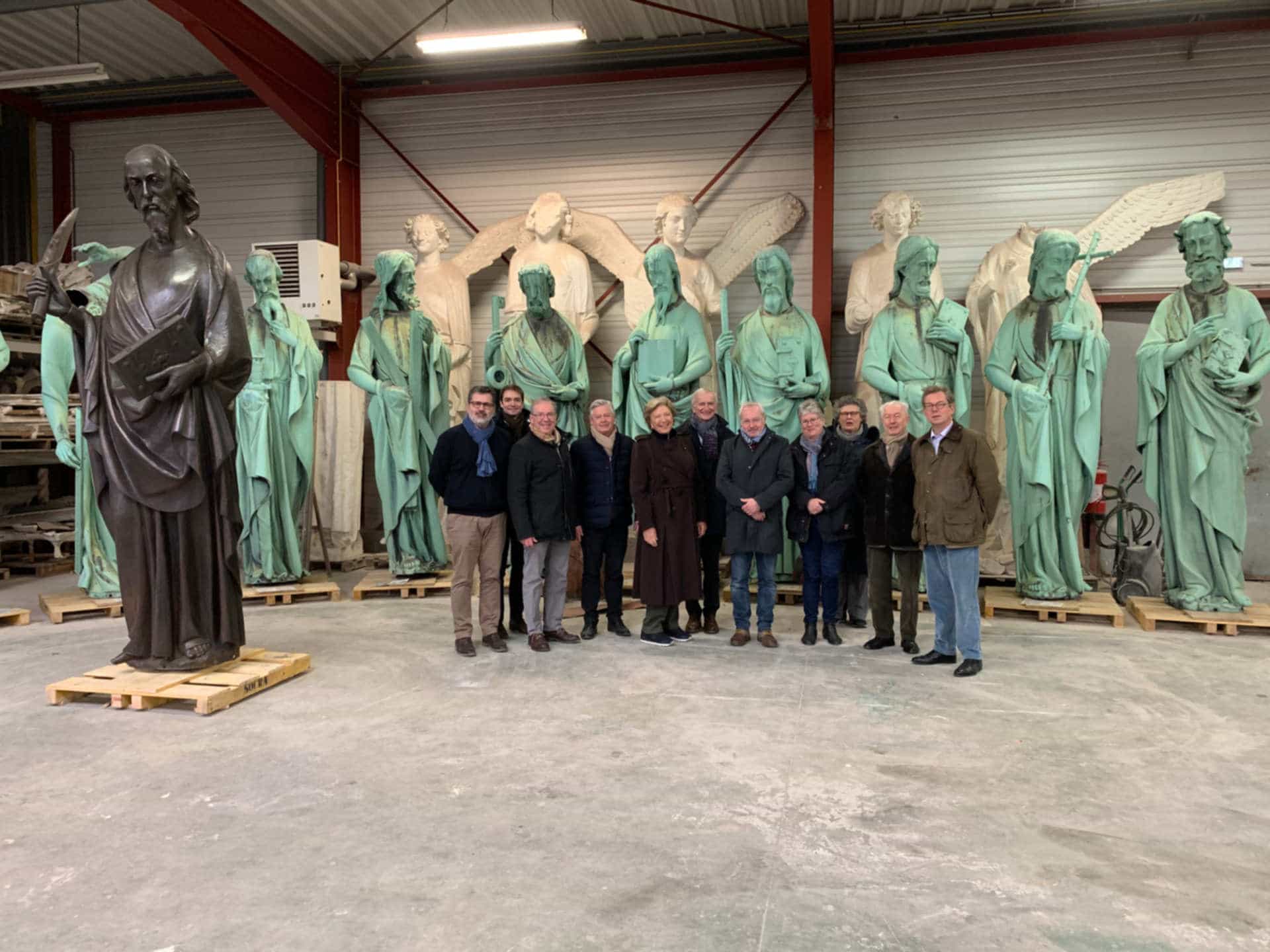 This picture shows the Friends of Notre-Dame de Paris team on a restoration site, before the fire. The picture depicts the statues of the Apostles in the background. This photo illustrates the section entitled:
